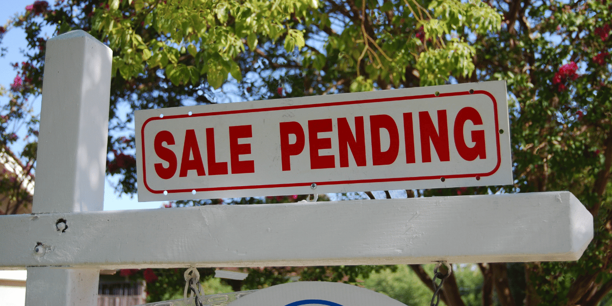 A for sale sign including a sale pending sign